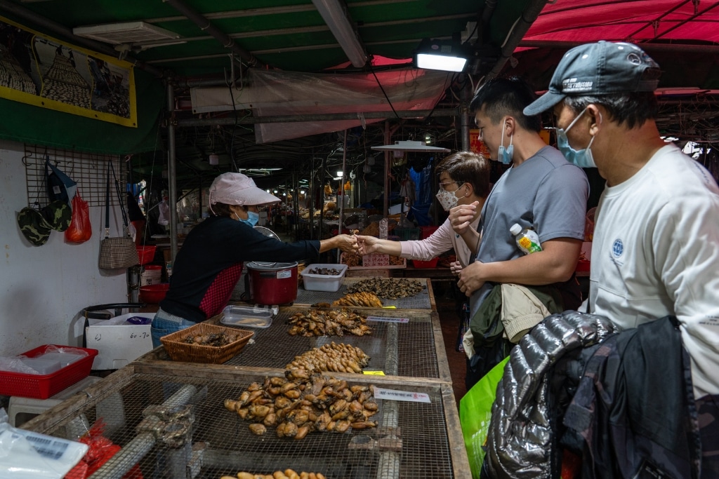 Visitors to Lau Fau Shan taste the village’s famous dried oysters. Residents hope a major new development project in the area will promote their oyster-farming traditions and boost tourism.